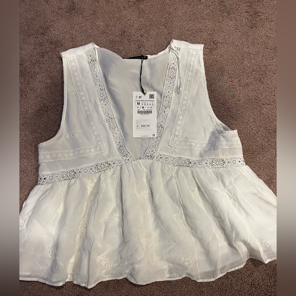White peplum plunging neck blouse